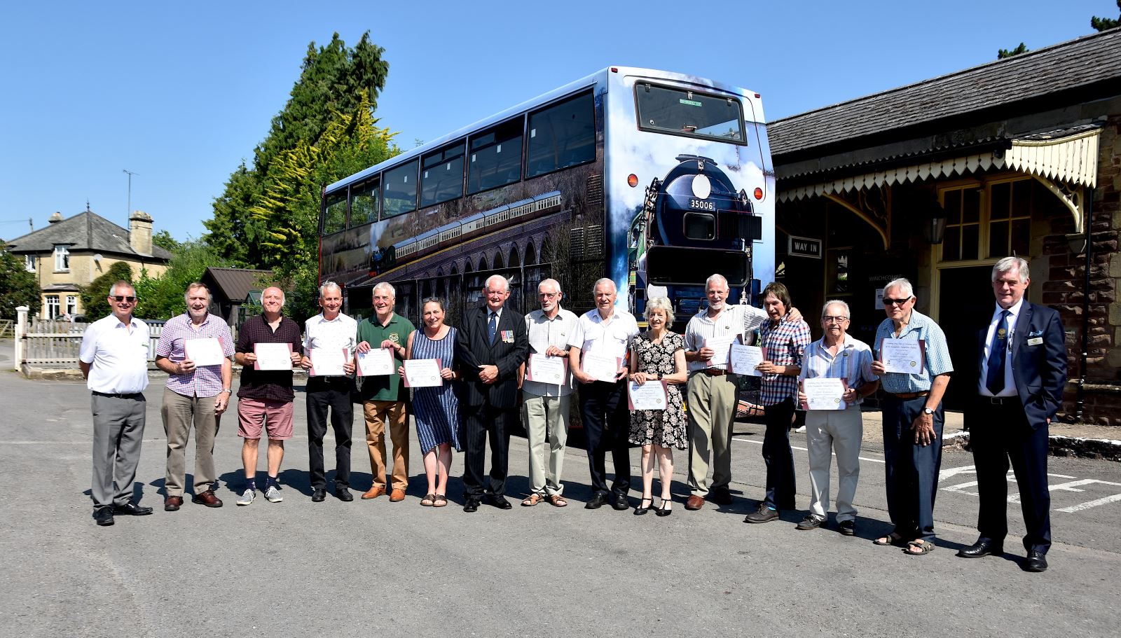 Award winners with left Glyn Cornish GWRT Chairman centre in suit Col Mike Bennett and extreme right Richard Johnson GWSR Plc chairman